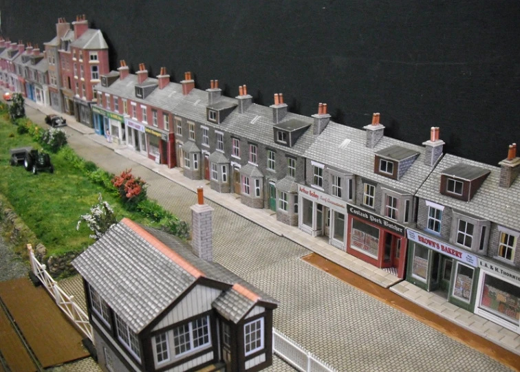 an overhead s of a train model with buildings and car parks