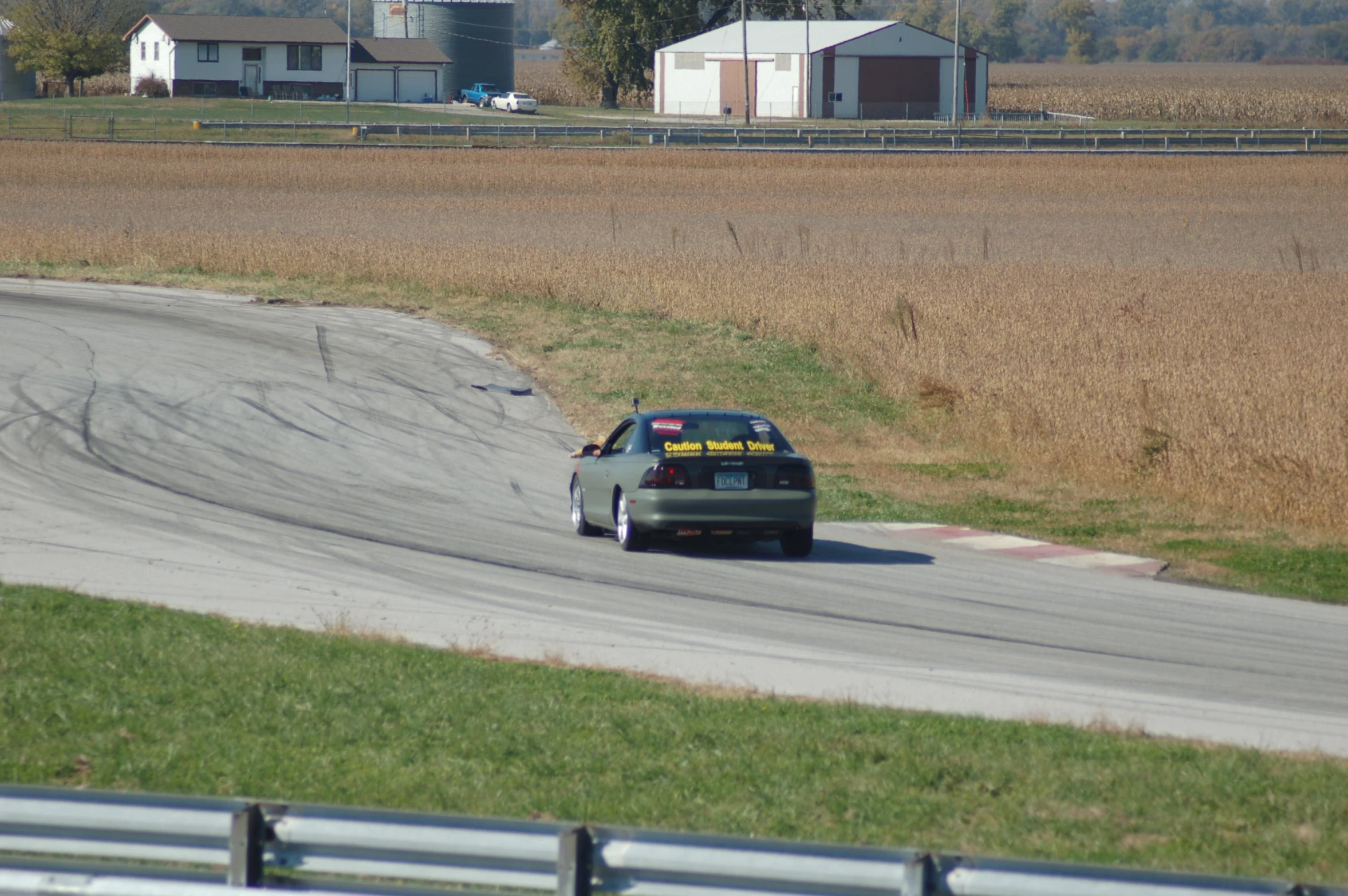 a car driving down a curved road in a town