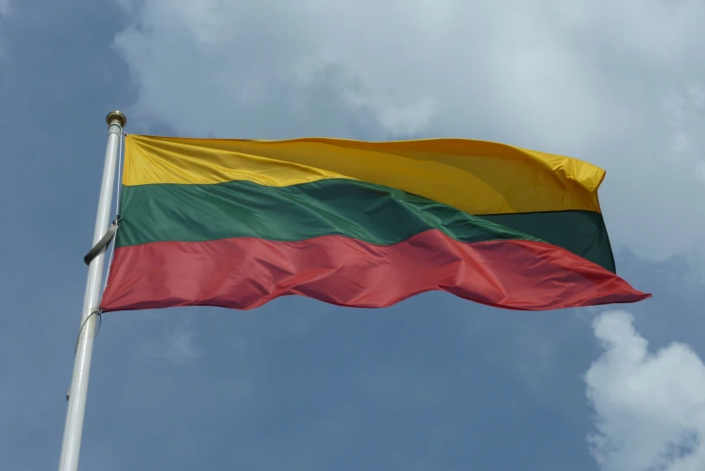 an extremely big and colorful flag flying in the wind