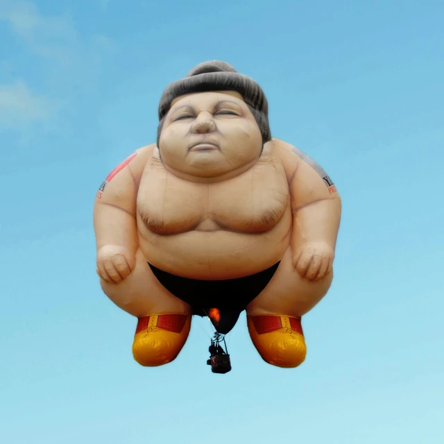 a big balloon that has a sumo sitting on top of it