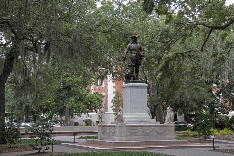 a monument stands in front of trees and lawn