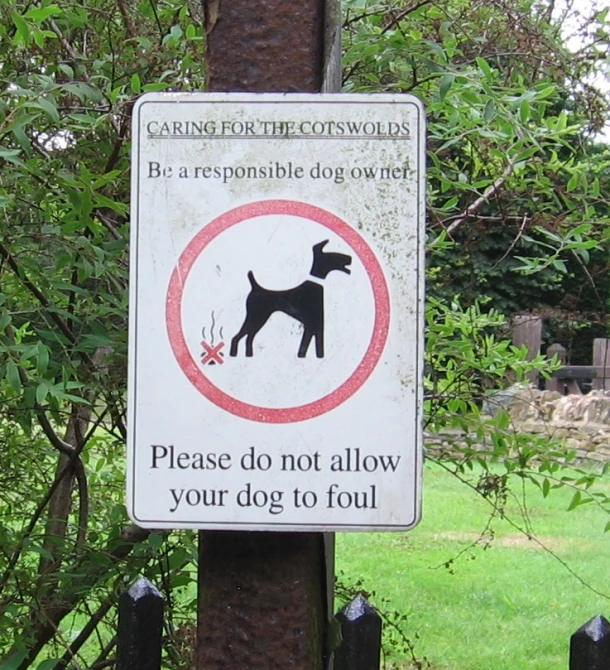 a sign about having pets is displayed on the pole