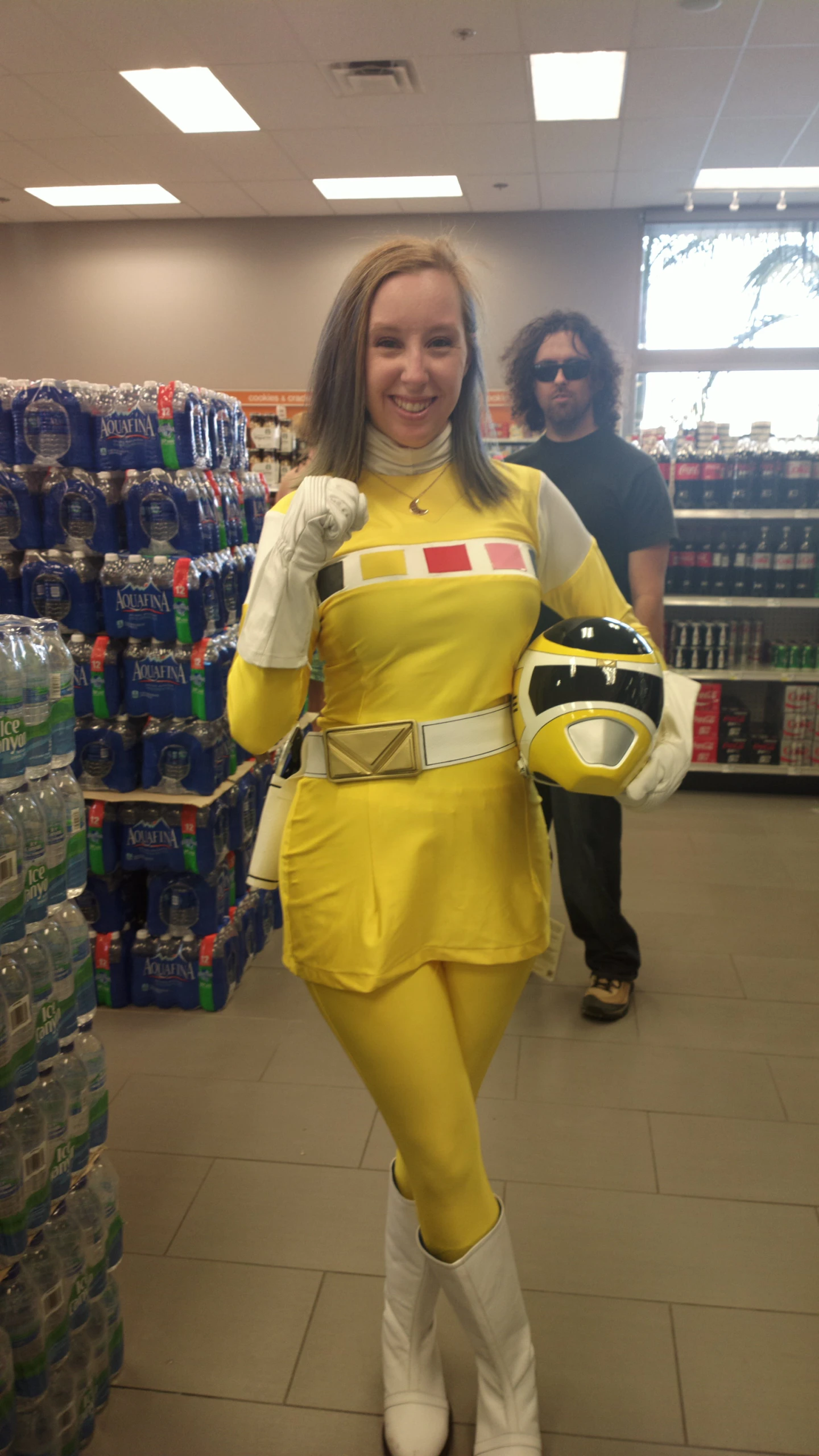 a woman in a costume holding some cans in her hands