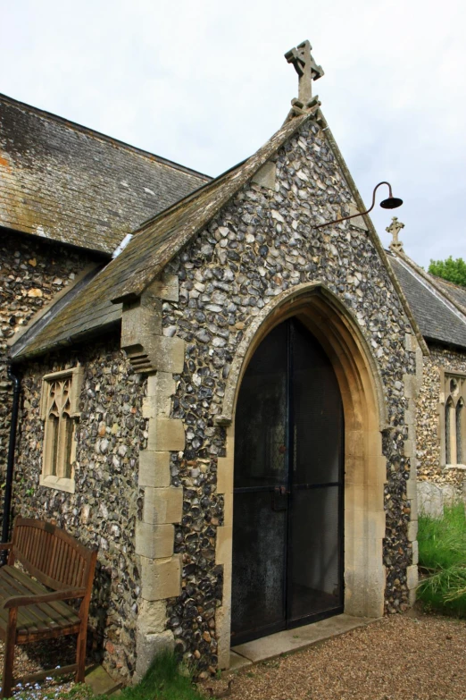 a stone church with a cross on top