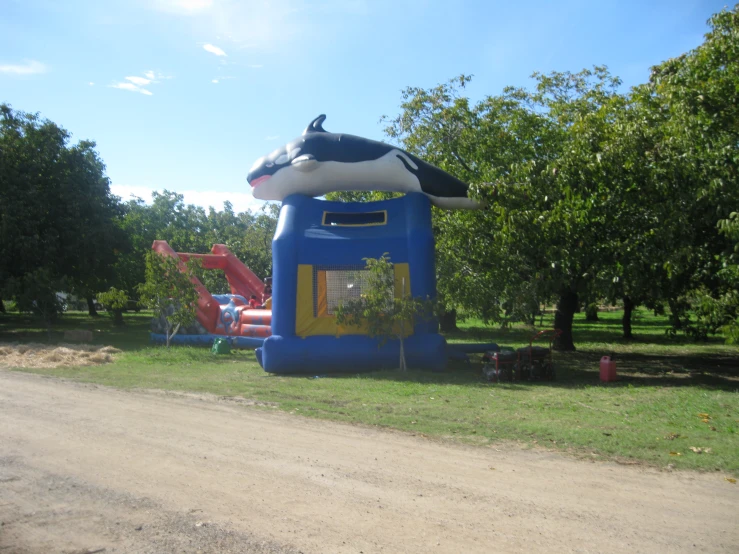 the inflatable shark is on display beside a park