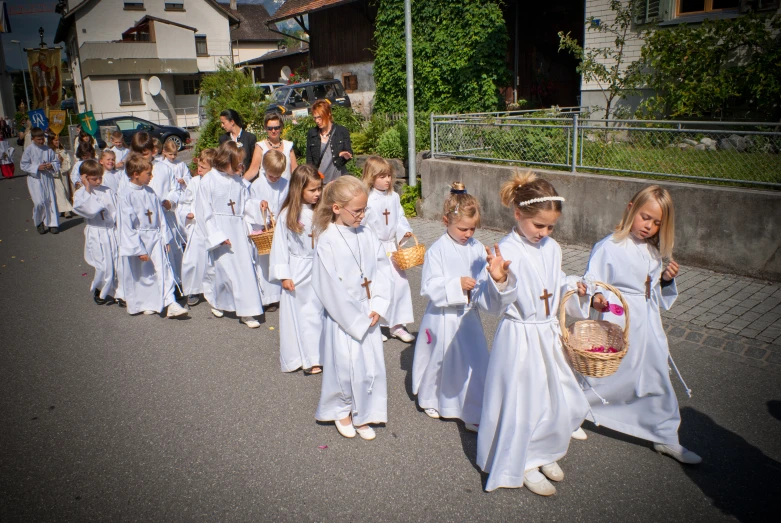 a bunch of children dressed in white are lined up