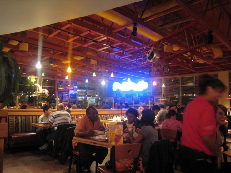 a large restaurant filled with people sitting at tables