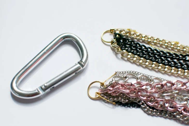 this is a chain - link keychain and a pair of metal eyeglasses