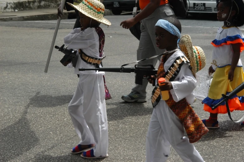 two little girls wearing hats and holding guns