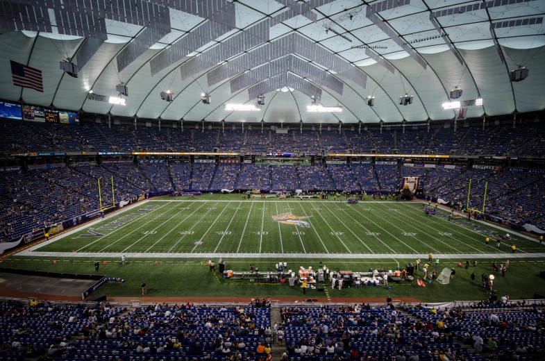 a view of a sports stadium and field with people playing football