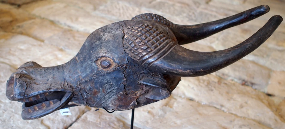 an elephant's head is mounted on a brick wall