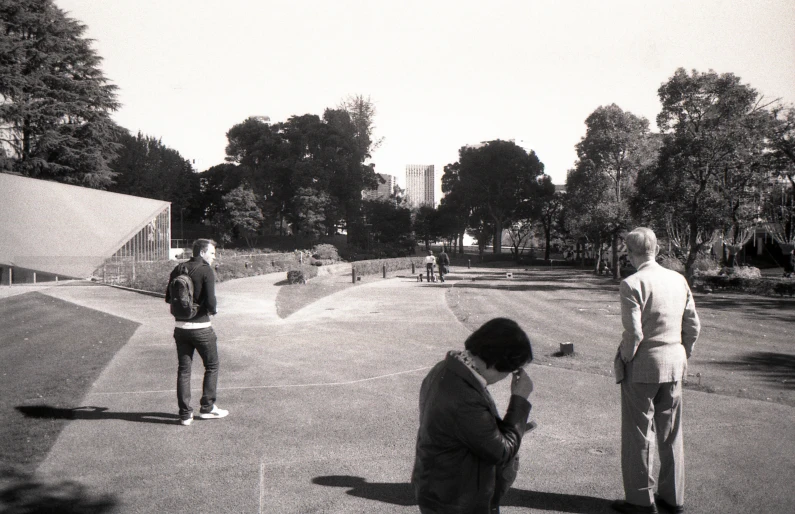 a man sitting down with two others on his knees