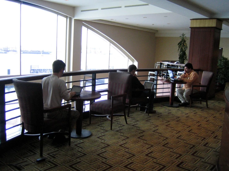 a couple of people sitting at a table in an airport