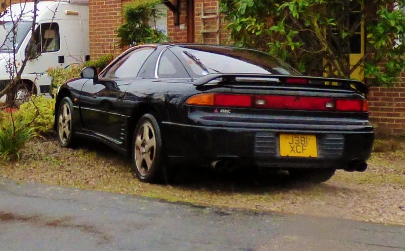 a car parked near a building in the grass