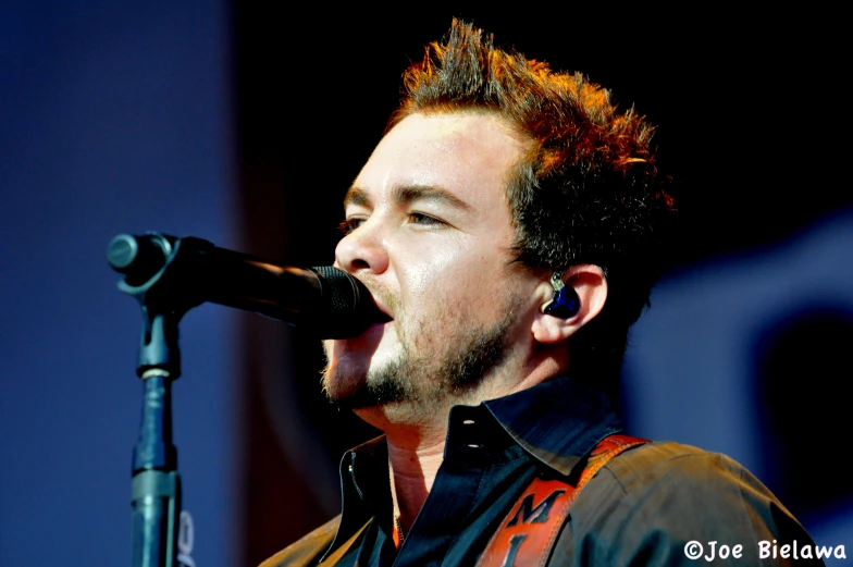 a close up of a person with an acoustic guitar