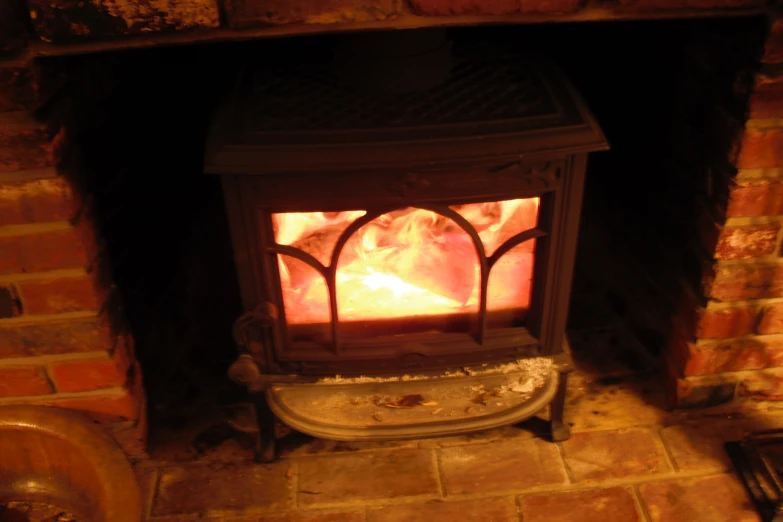 a fireplace is lit with a wood burning stove