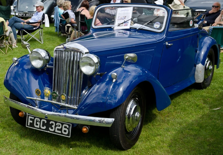 a classic car on display at an outdoor event