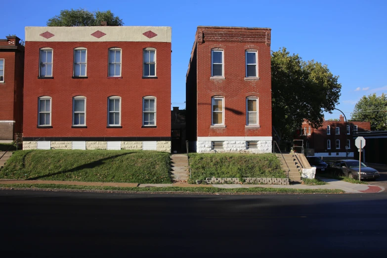 two large brick buildings next to a road