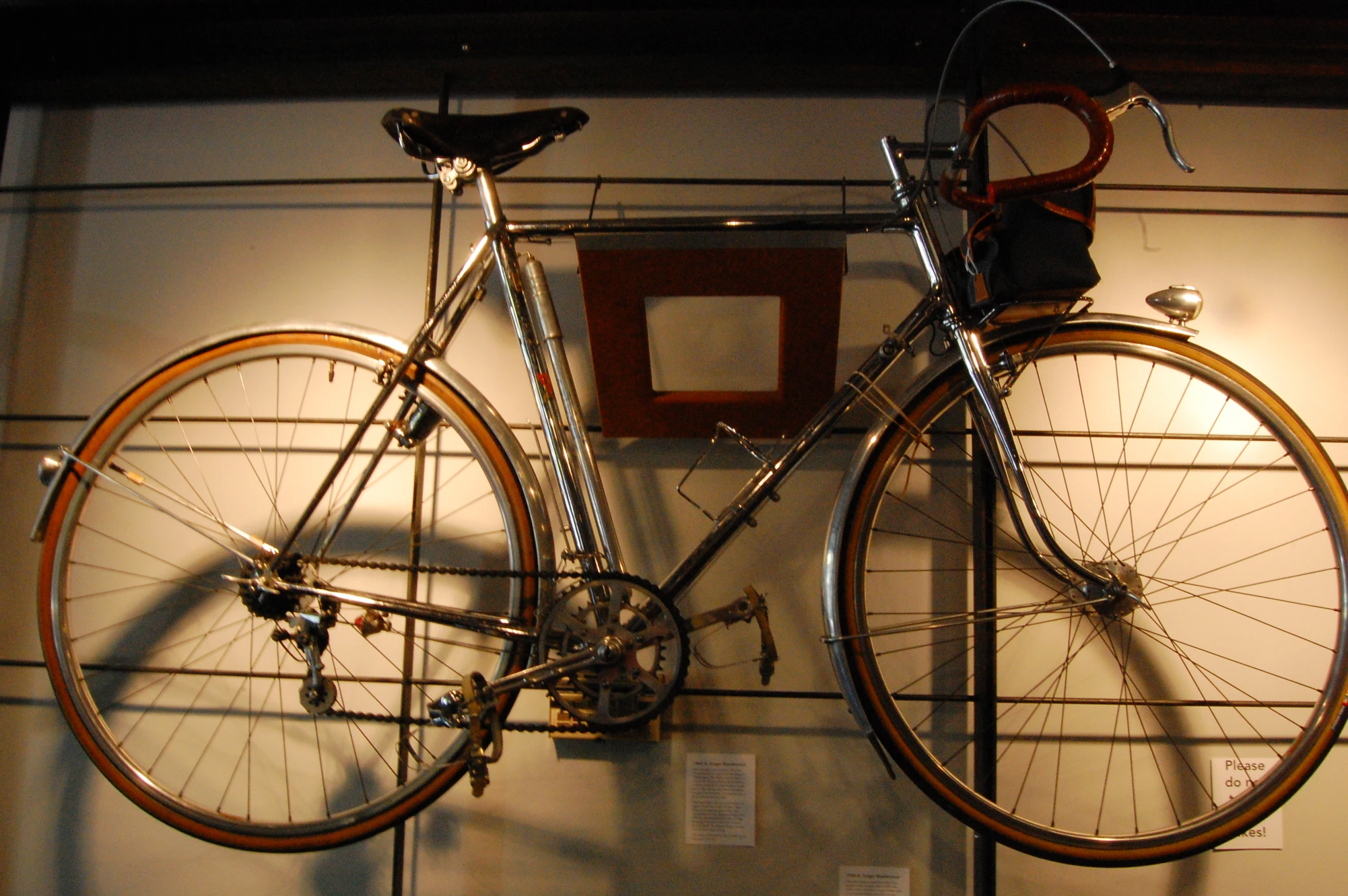 a bike mounted on the wall near a chair