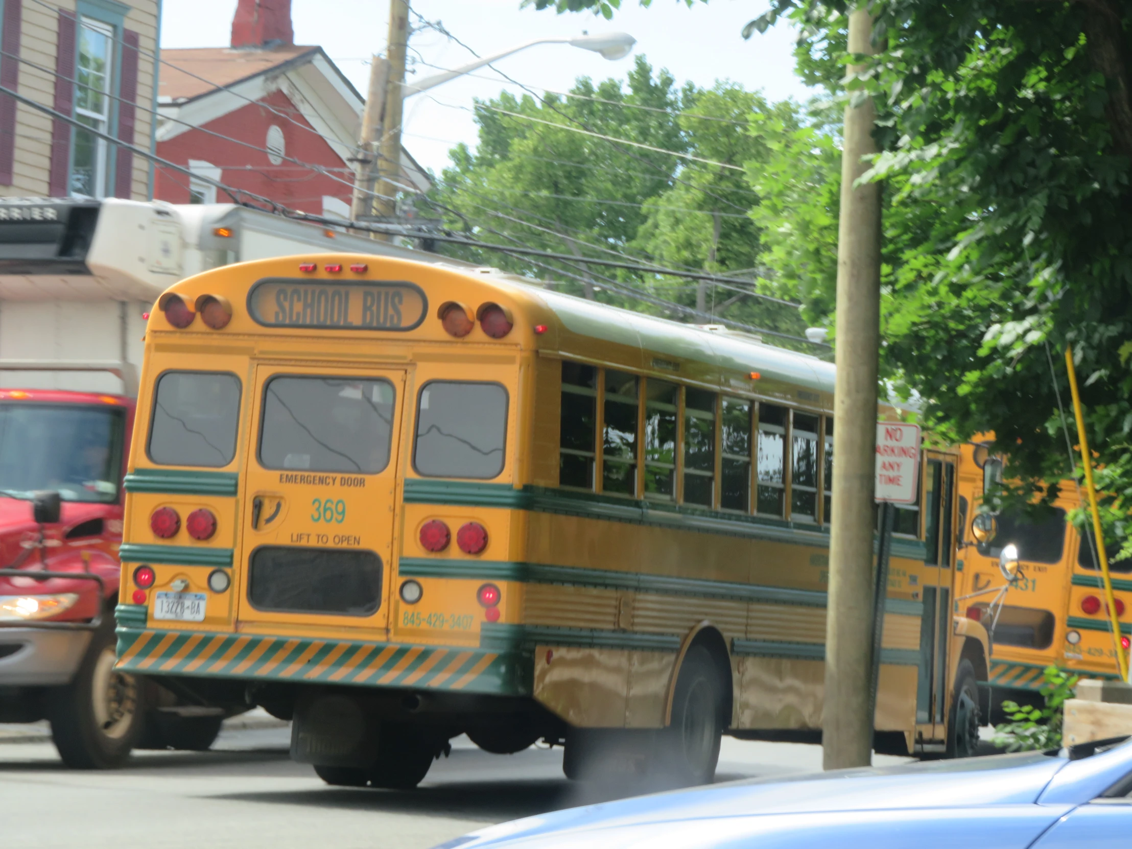 two school buses stopped at a bus stop
