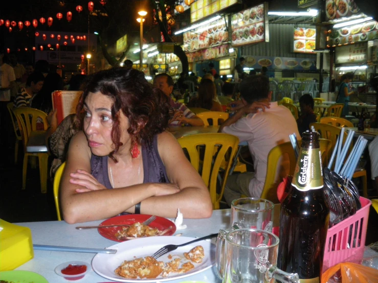 a woman sitting at a table in front of food