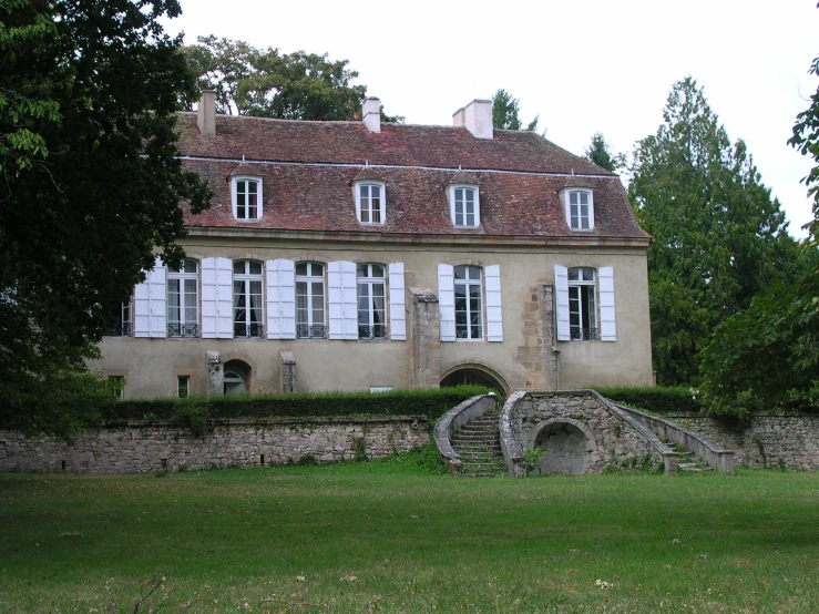 an old building with windows on a hill