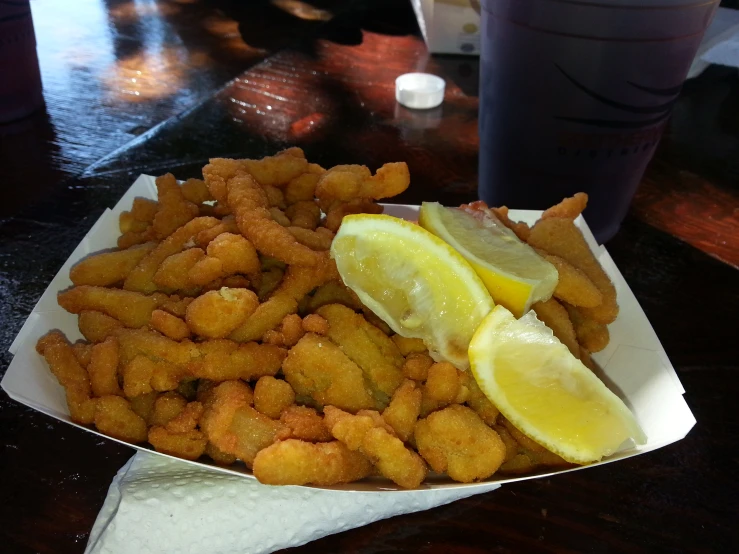 the plate is full of tater tots and lemon slices