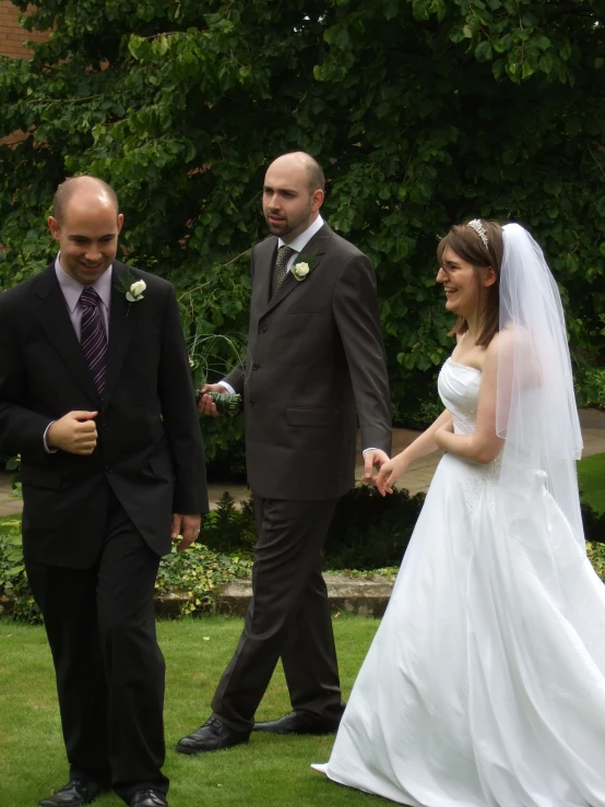 bride and groom standing in front of a wedding couple