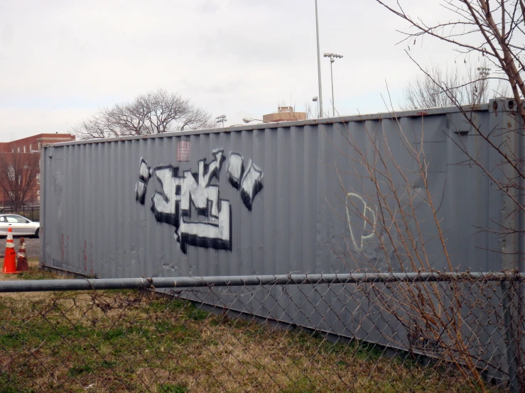 a very large metal structure with some graffiti on it
