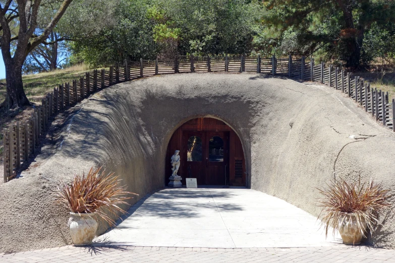 a stone tunnel entrance to an artificial world