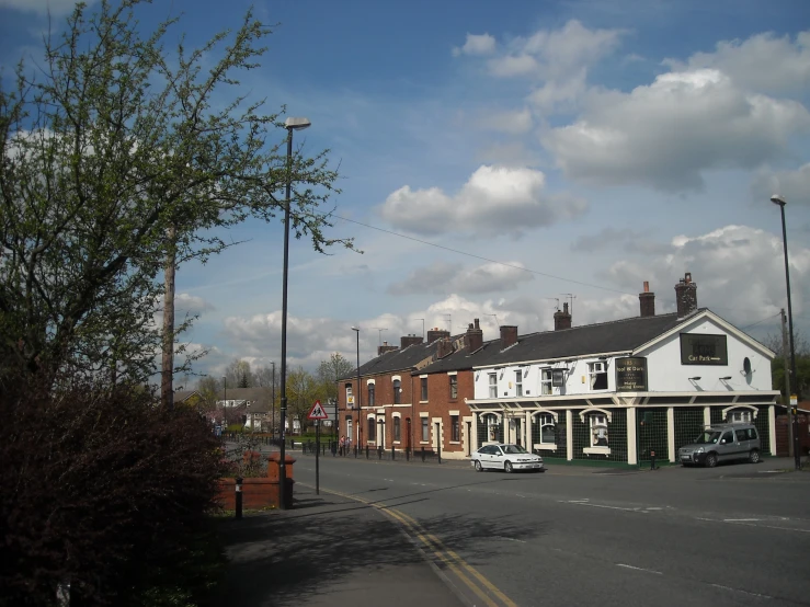 a residential street with trees lining both sides