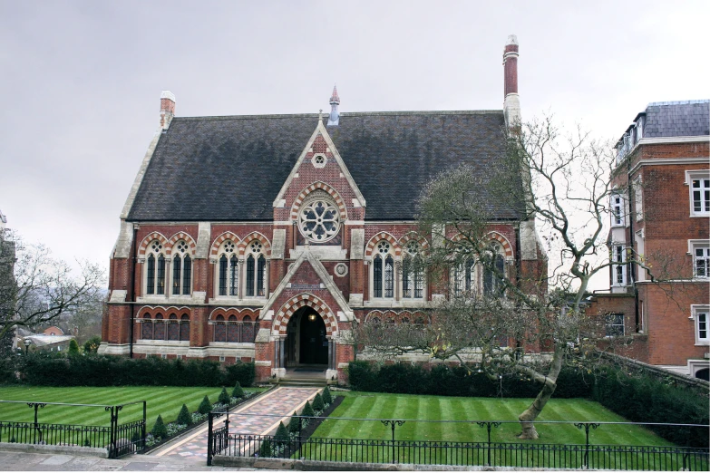 the large red brick building has a massive clock on it