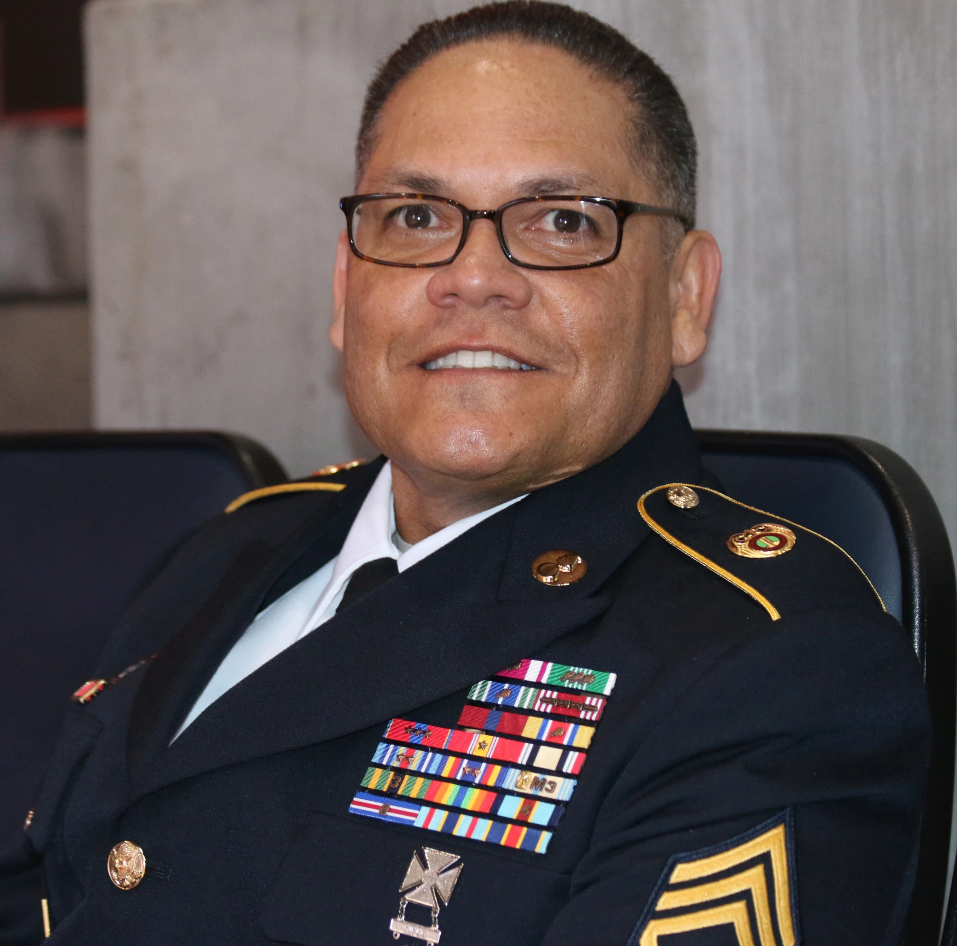 man in uniform sitting with arms folded