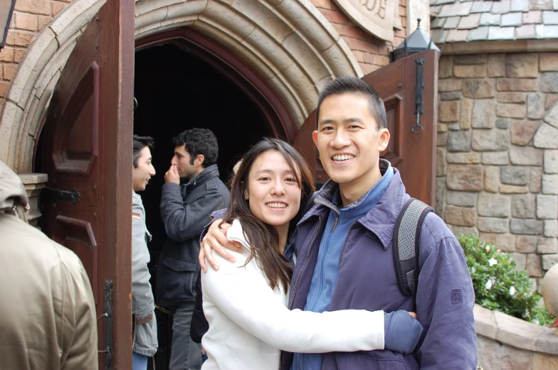 a couple emce in front of a tall building