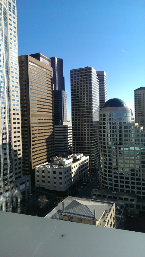 some buildings a street and a few cars