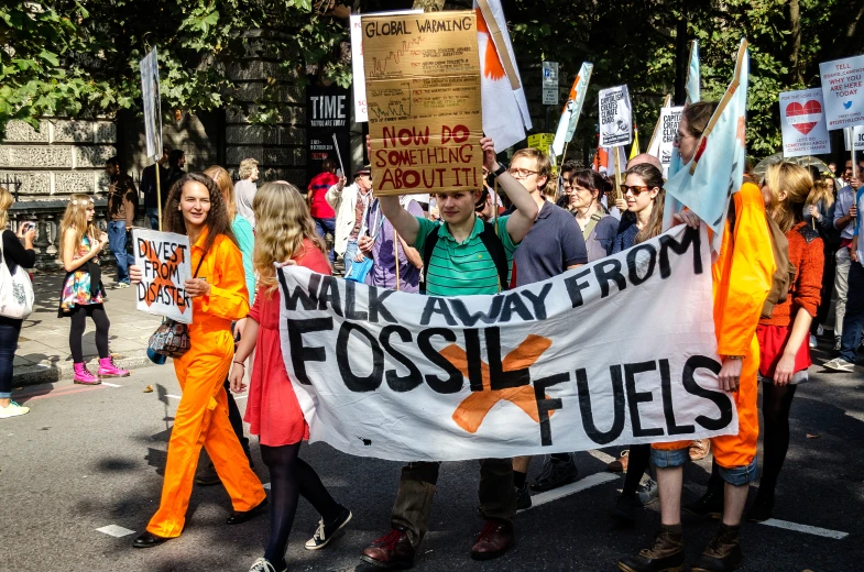 a group of people marching with protest signs