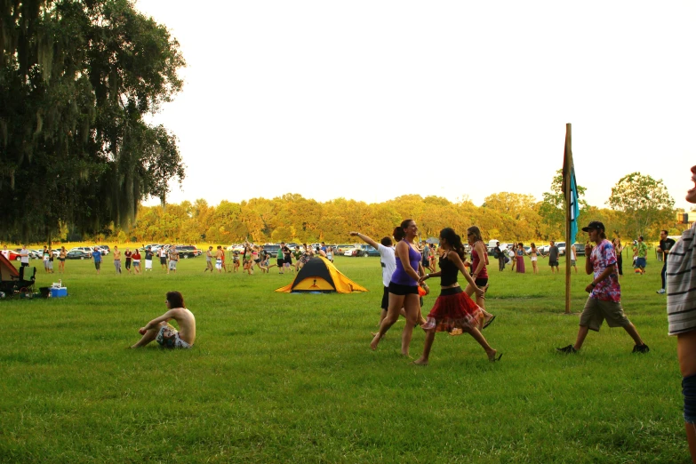 people playing basketball on the grass in a field