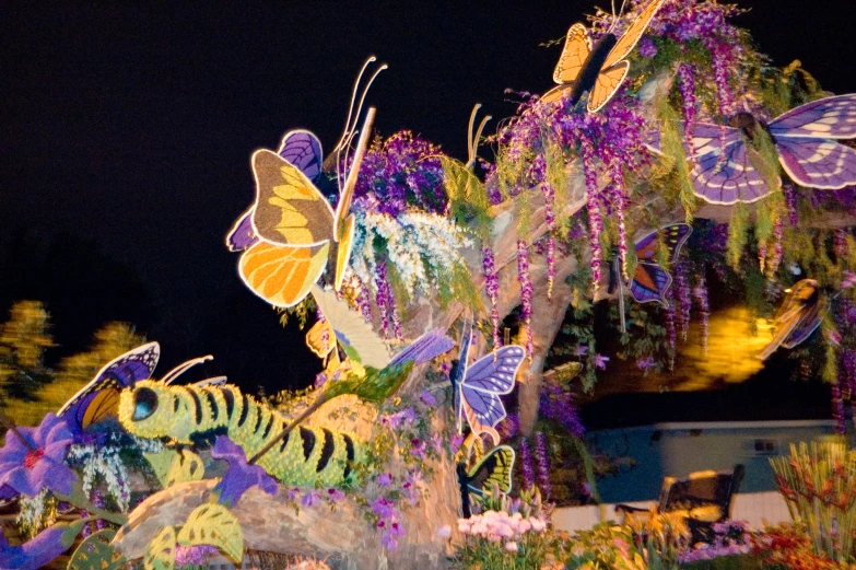 a display of colorful flowers and erfly decorations