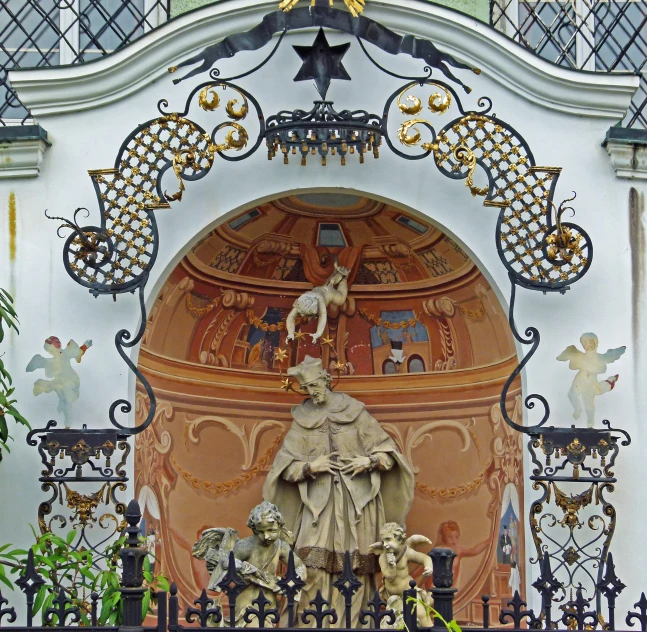 a large statue with an eagle on it by the fence