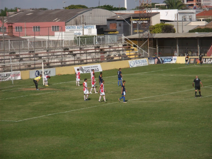 several people in uniforms on a soccer field