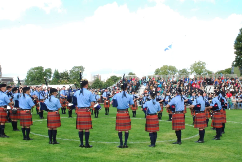a group of men in kilts are marching