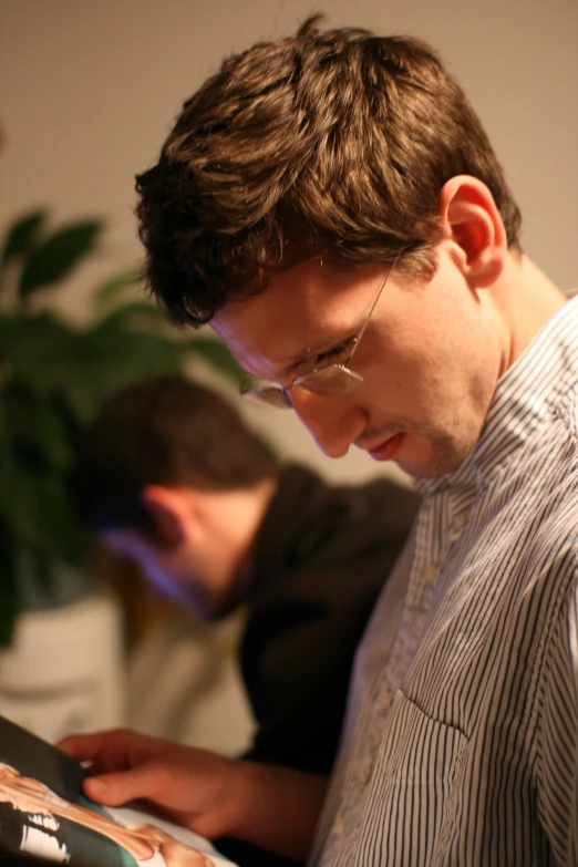 a man reading a book in an office