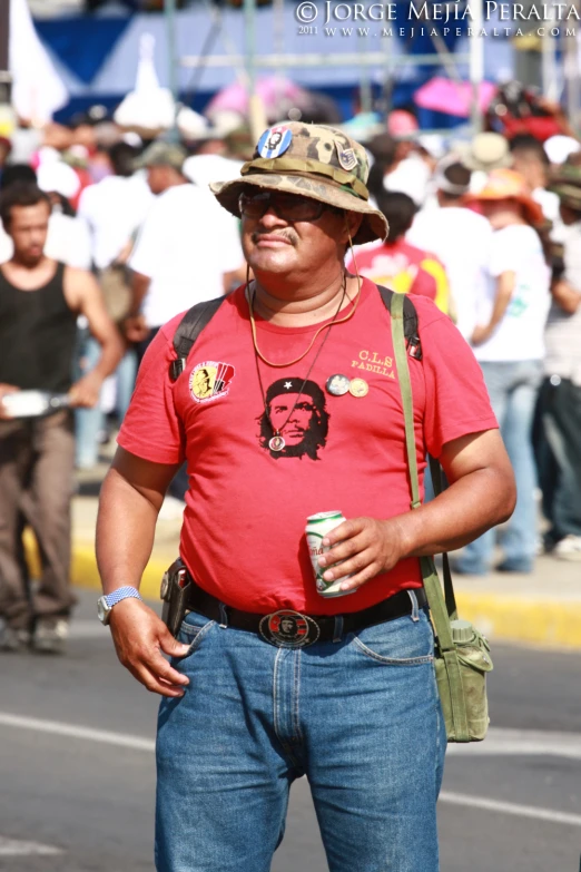 a man with a funny hat on is drinking a drink