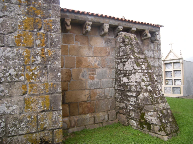 two stone structures are in the middle of grass