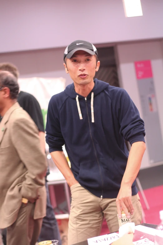 there is a man standing near a table with food