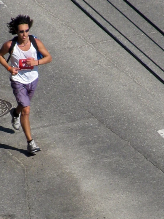 a woman is running down a city street