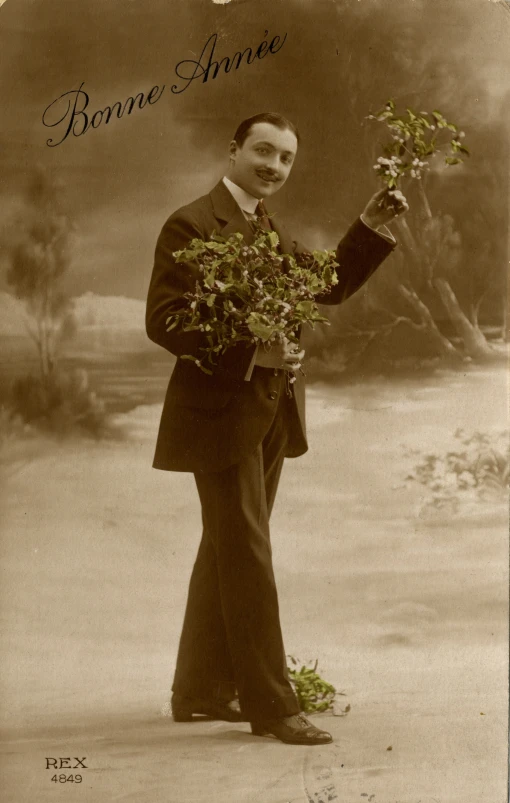 a man with a suit is holding some plants