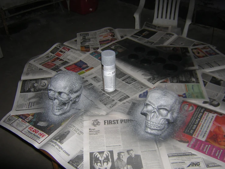 a newspaper spread with newspaper pages and a silver skull