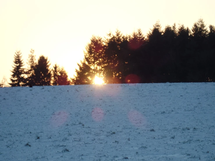 a person skiing across a snow covered slope