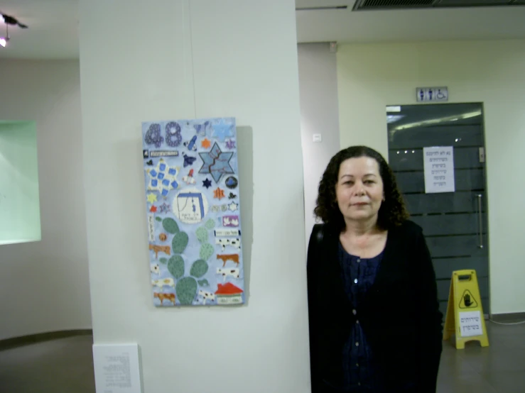 a woman standing next to an art piece